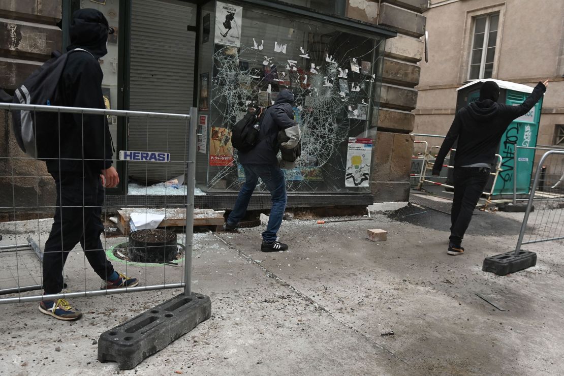 Protesters smash a shop window during unrest in Nantes in western France on June 30, 2023.