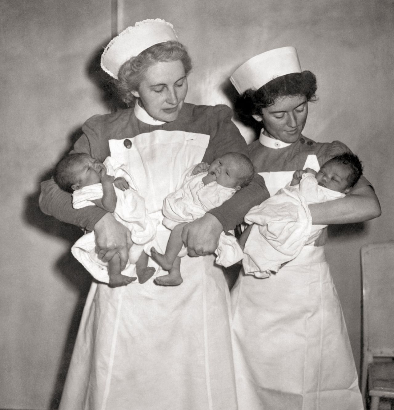 Nurses cradle the first babies to be born under the new National Health Service on 5th July 1948. Had they been born a day earlier, they would have cost their families one shilling and sixpence, according to new book 