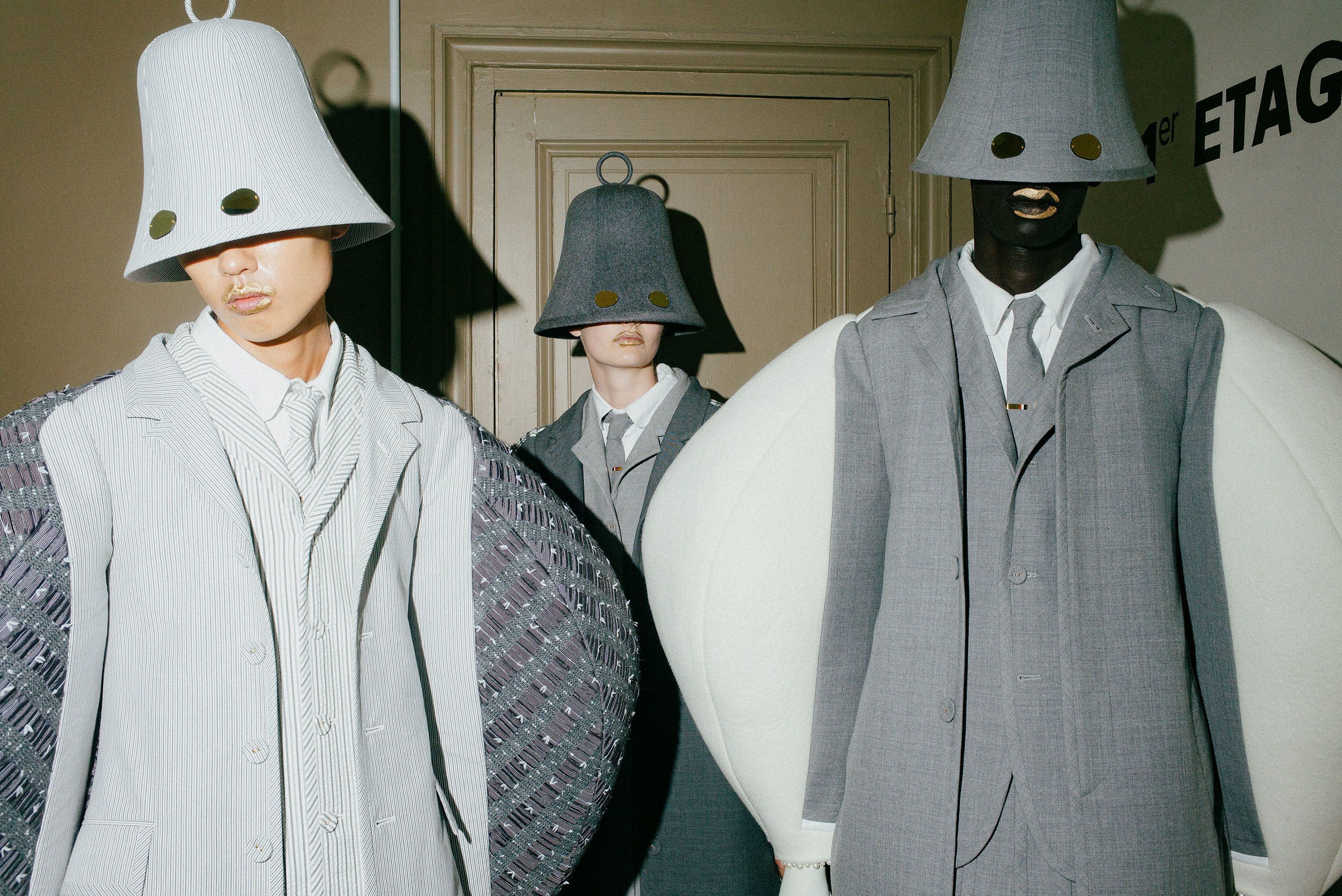 Station bells were also present, wearing enormous. bulging suits.