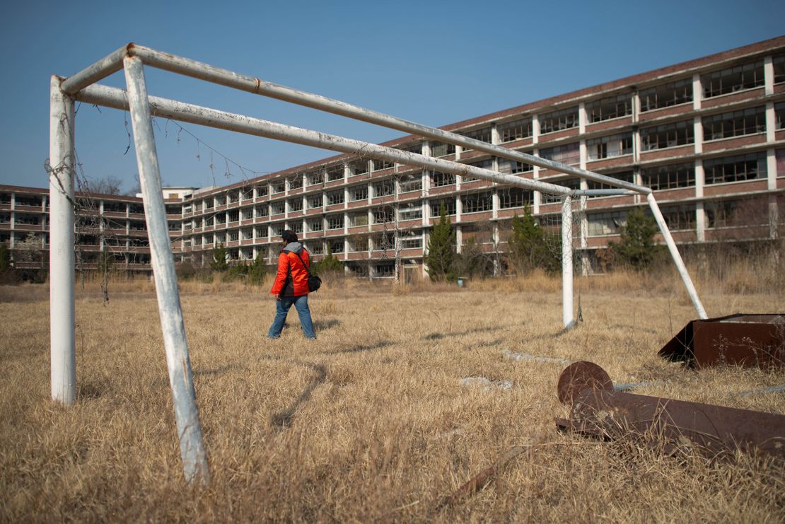 A photographer outside an abandoned school near Daejeon, South Korea, on March 22, 2014.