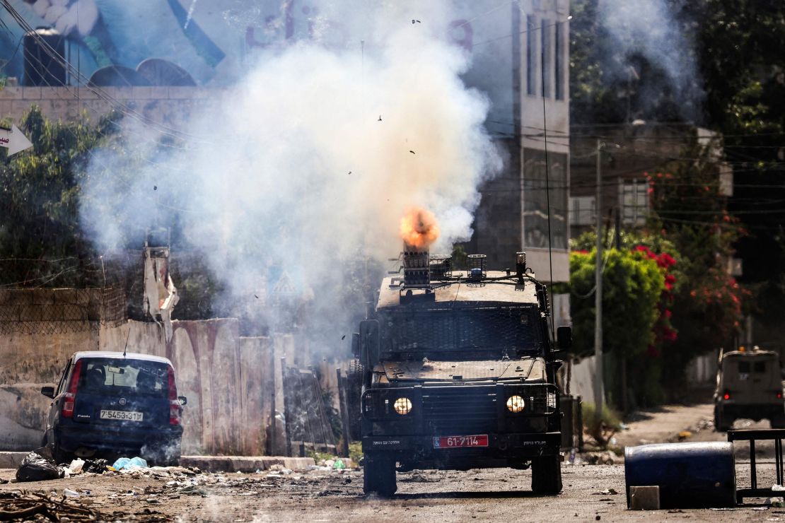 An Israeli armored vehicle fires tear gas during the military operation in Jenin in the occupied West Bank on July 4.