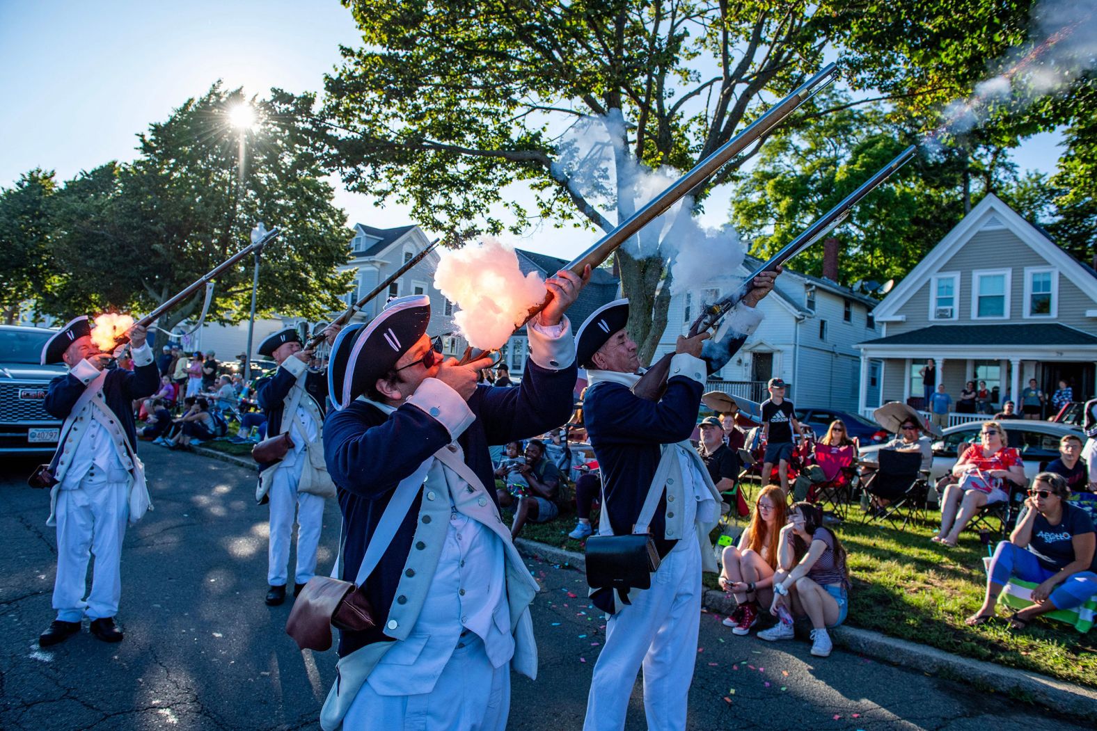 Colonial re-enactors fire their weapons during a parade in Gloucester, Massachusetts, on Monday, July 3.