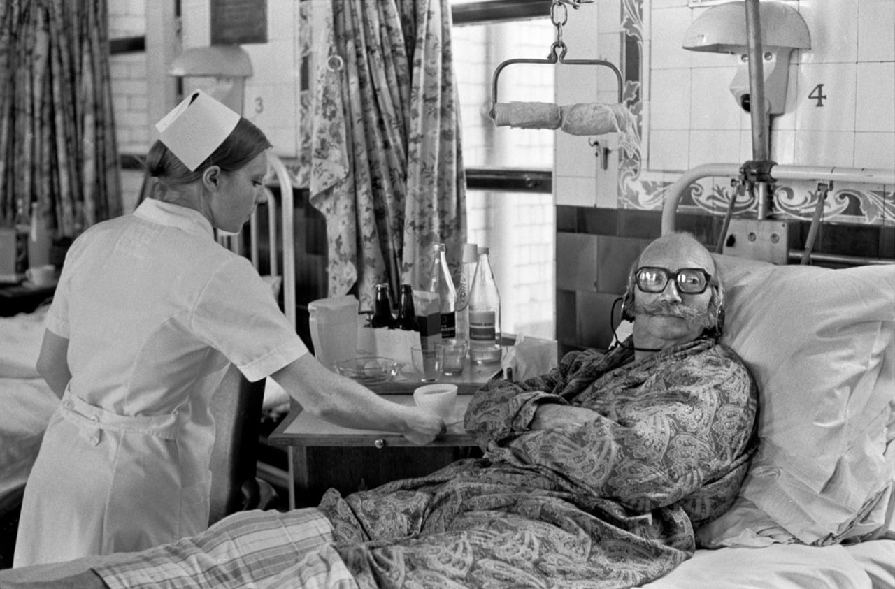 A patient at London's Charing Cross Hospital watches TV with headphones in 1972.
