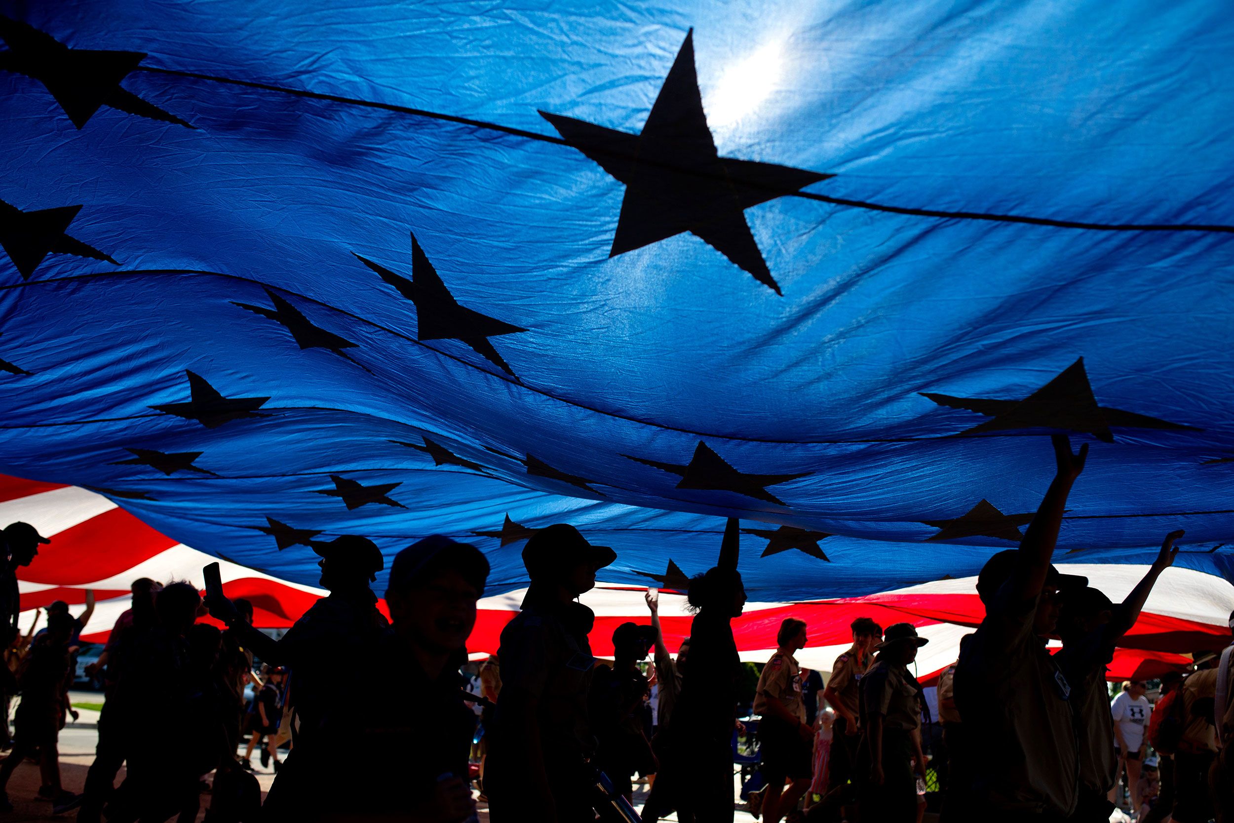 Boy Scouts carry a large American flag during a Fourth of July parade in Edmond, Oklahoma, on Tuesday.