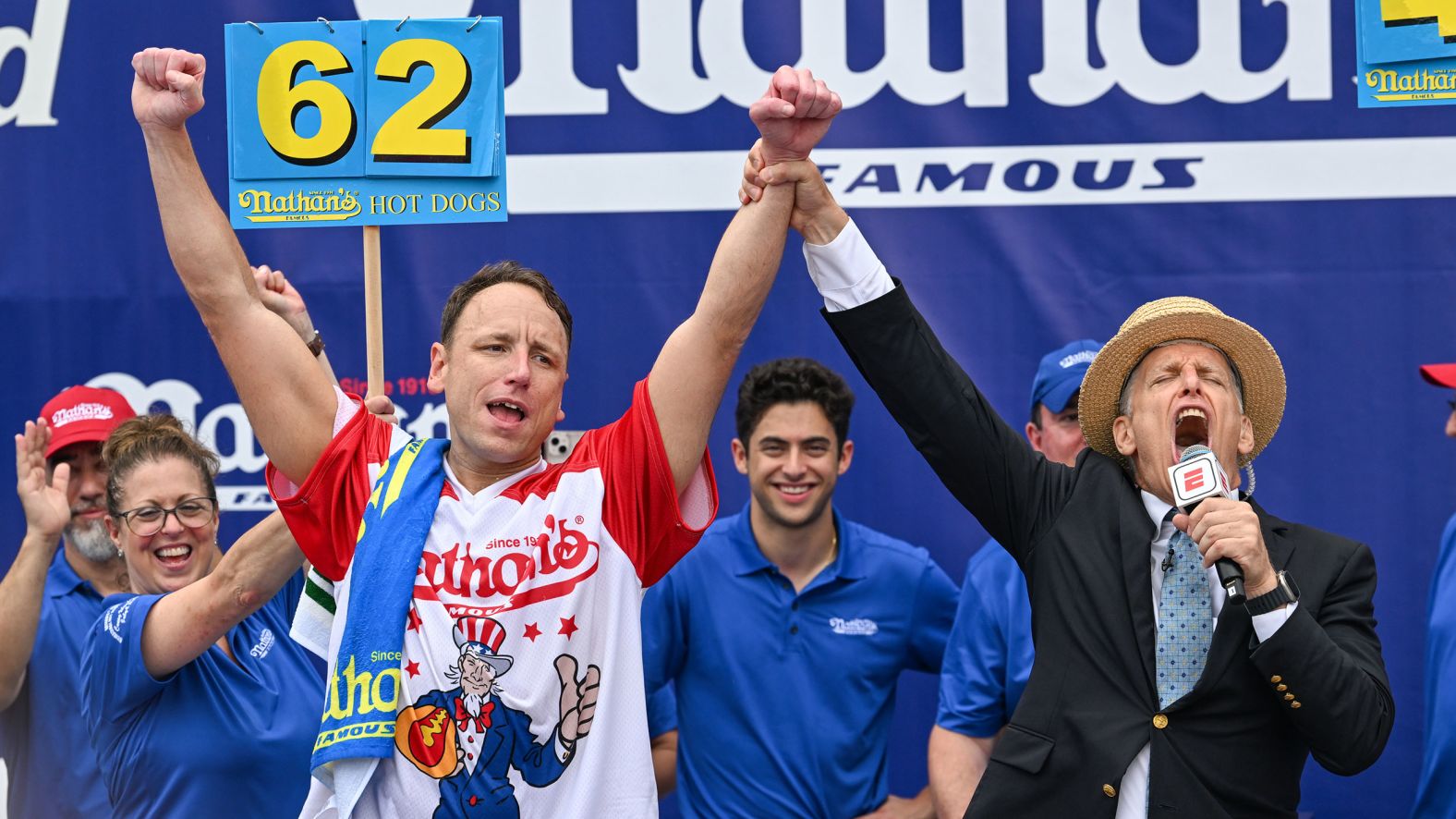Joey Chestnut raises his arms in celebration Tuesday after successfully defending his title in the Nathan's Famous International Hot Dog Eating Contest, which takes place every year in New York. He ate 62 hot dogs and buns in 10 minutes.
