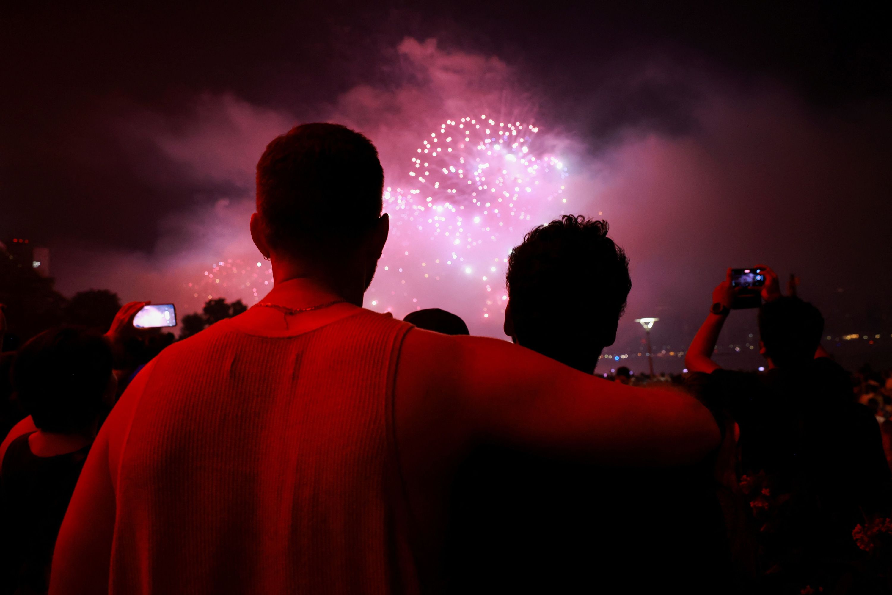 Spectators watch the Macy's Fourth of July fireworks in New York City on Tuesday, July 4.