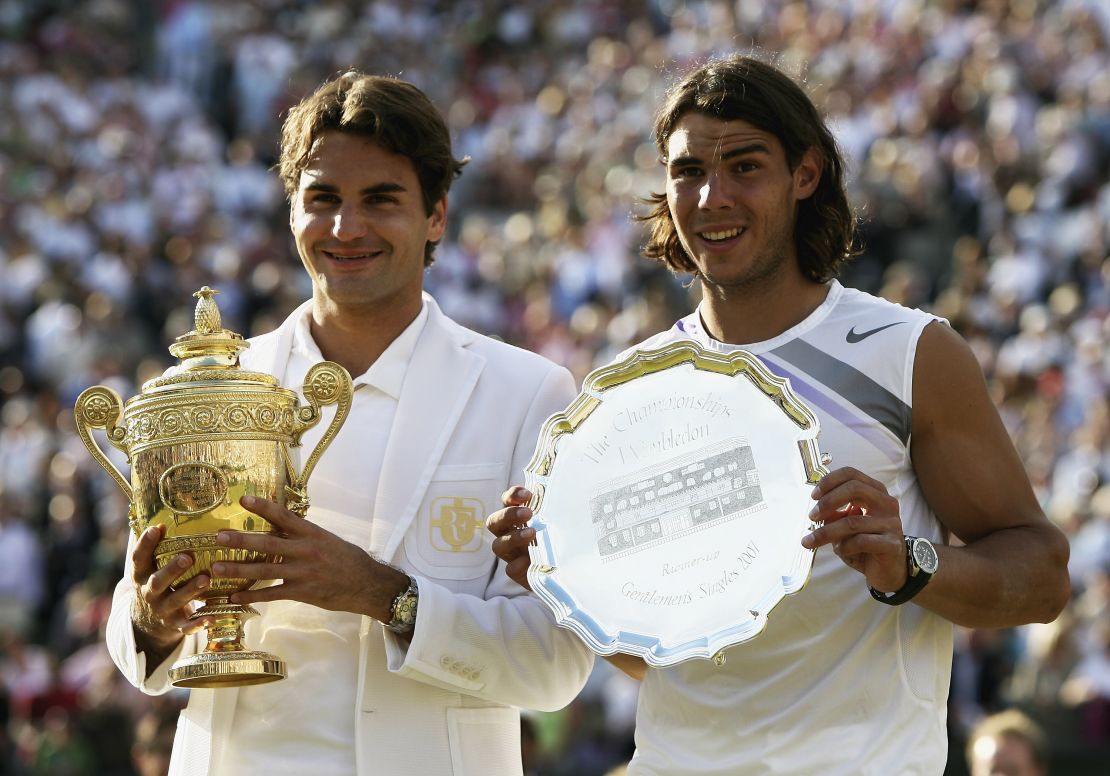 LONDON - JULY 08:  Roger Federer of Switzerland poses with the winners trophy alongside runner-up Rafael Nadal of Spain following the Men's Singles final match during day thirteen of the Wimbledon Lawn Tennis Championships at the All England Lawn Tennis and Croquet Club on July 8, 2007 in London, England. Roger Federer claims his fifth consecutive championship title.  (Photo by Clive Brunskill/Getty Images)