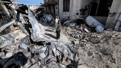TOPSHOT - People stand by rubble and the remains of a destroyed vehicle outside a mosque in the occupied West Bank city of Jenin on July 5, 2023, after the Israeli army declared the end of a two-day military operation in the area. The Israeli military launched the raid on the Jenin refugee camp early on July 3, during which 12 Palestinians and one Israeli soldier were killed. (Photo by AHMAD GHARABLI / AFP) (Photo by AHMAD GHARABLI/AFP via Getty Images)