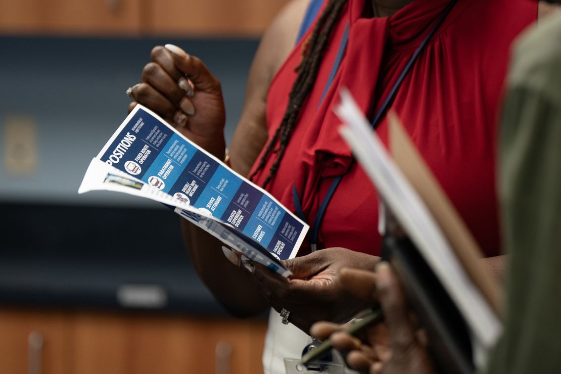 A woman holds a flyer at a career fair hosted by the New Hanover NCWorks and the Cape Fear Workforce Development Board in Wilmington, North Carolina, on Tuesday, June 20, 2023. 