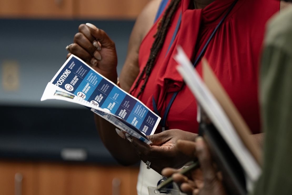 A woman holds a flyer at a career fair hosted by the New Hanover NCWorks and the Cape Fear Workforce Development Board in Wilmington, North Carolina, on Tuesday, June 20, 2023.