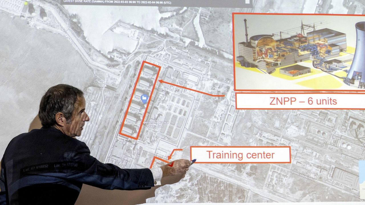 Grossi points on a map of the Zaporizhzhia nuclear power plant, March 2022.