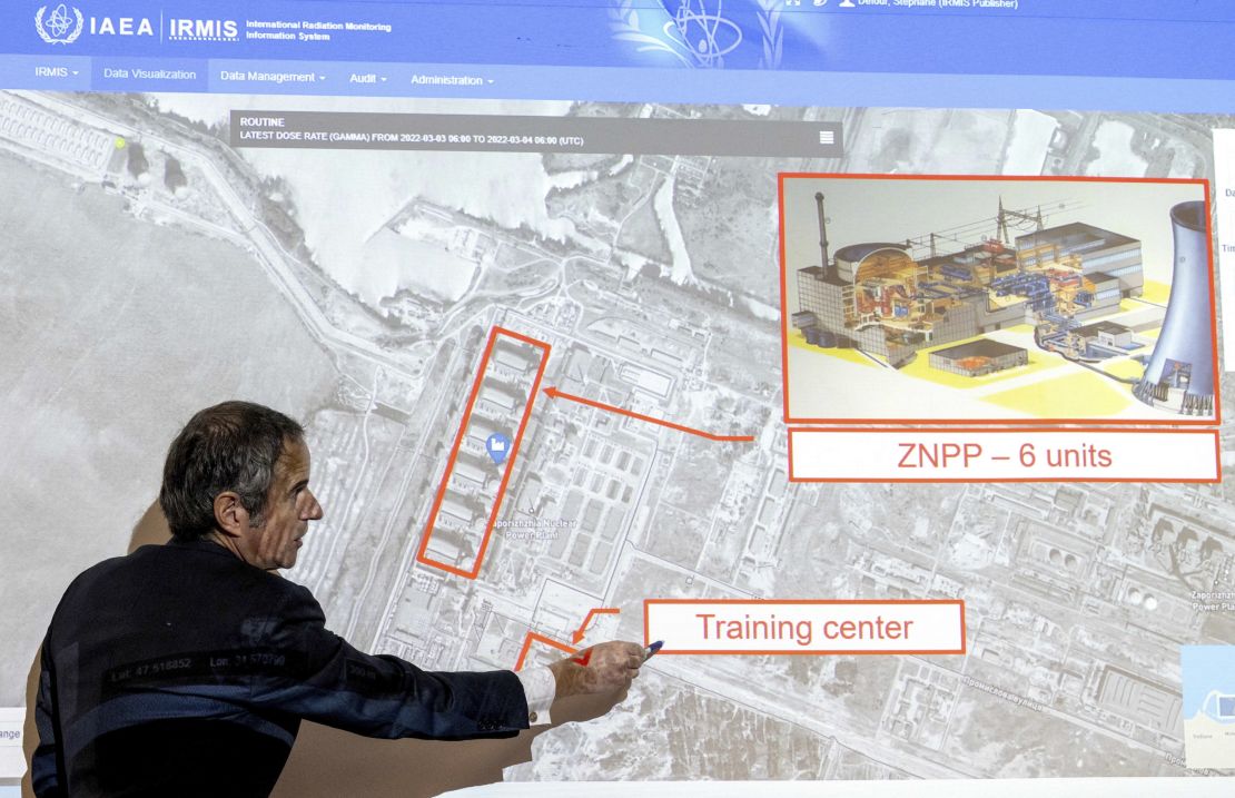 Grossi points on a map of the Zaporizhzhia nuclear power plant, March 2022.