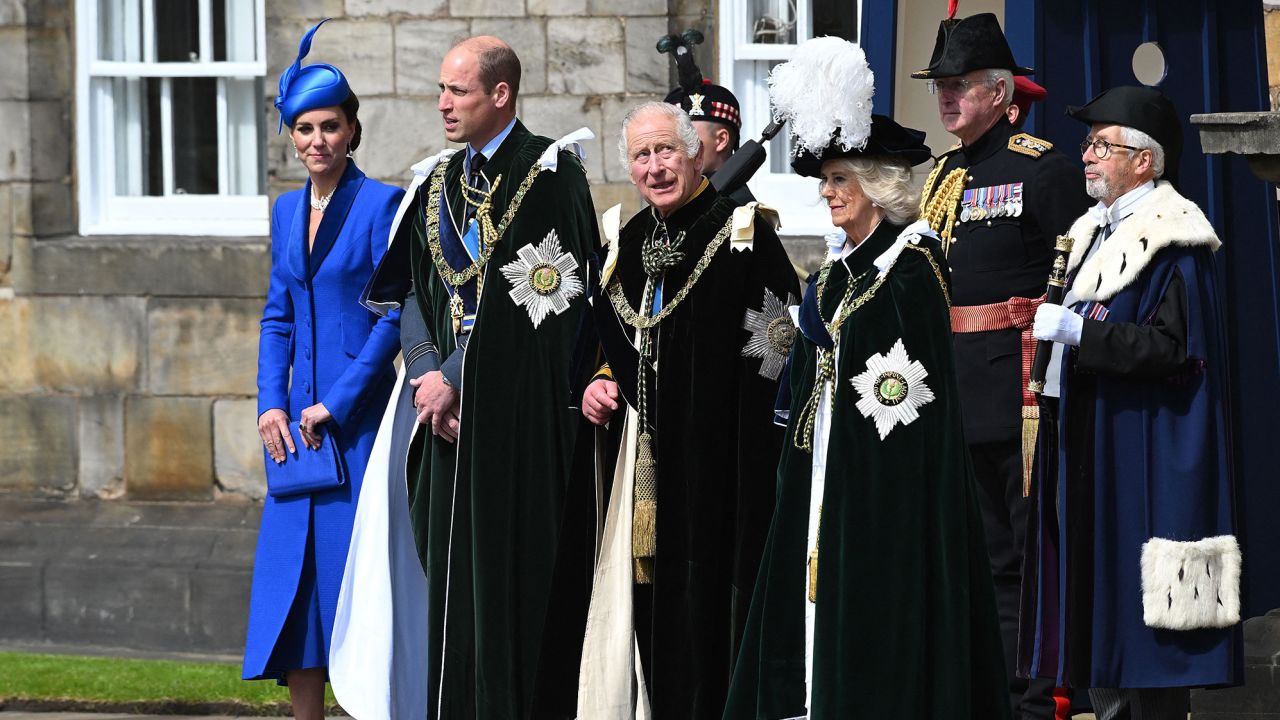 King Charles III stands with Camilla and  William and Kate, the Duke and Duchess of Rothesay, outside the Palace of Holyroodhouse to watch the RAF flypast. 