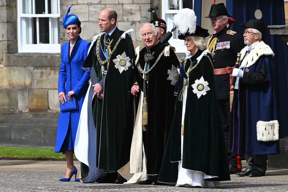 King Charles III stands with Camilla and  William and Kate, the Duke and Duchess of Rothesay, outside the Palace of Holyroodhouse to watch the RAF flypast. 