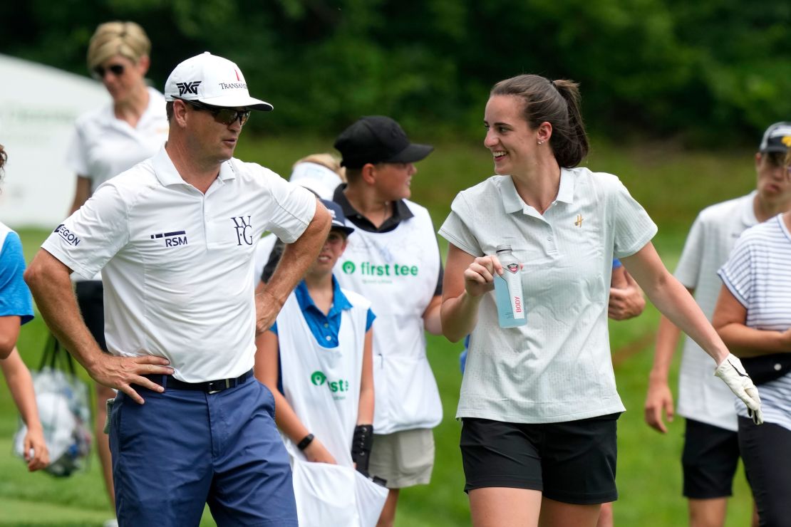 Zach Johnson talks with Iowa basketball player Caitlin Clark, right, while walking on the 16th fairway during the John Deere Classic golf tournament Pro-Am, Wednesday, July 5, 2023, at TPC Deere Run in Silvis, Ill. (AP Photo/Charlie Neibergall)