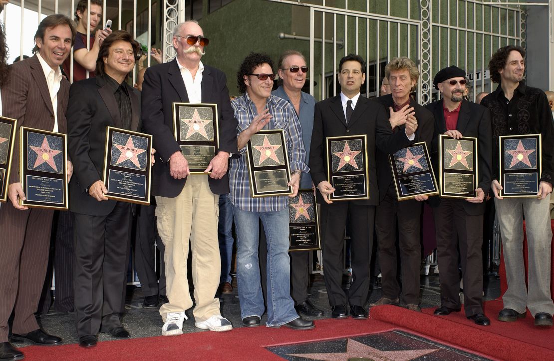 Rock group Journey bandmembers Jonathan Cain, Steve Perry, George Tickner, Neal Schon, Aynsley Dunbar (rear), Robert Fleischman, Ross Valory, and Steve Smith (beret) at their star ceremony where they were honored on the Hollywood Walk of Fame in 2005.