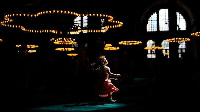 A child walks under a spot light at the Byzantine-era Hagia Sophia mosque in Istanbul, Wednesday, July 5, 2023. (AP Photo/Francisco Seco)