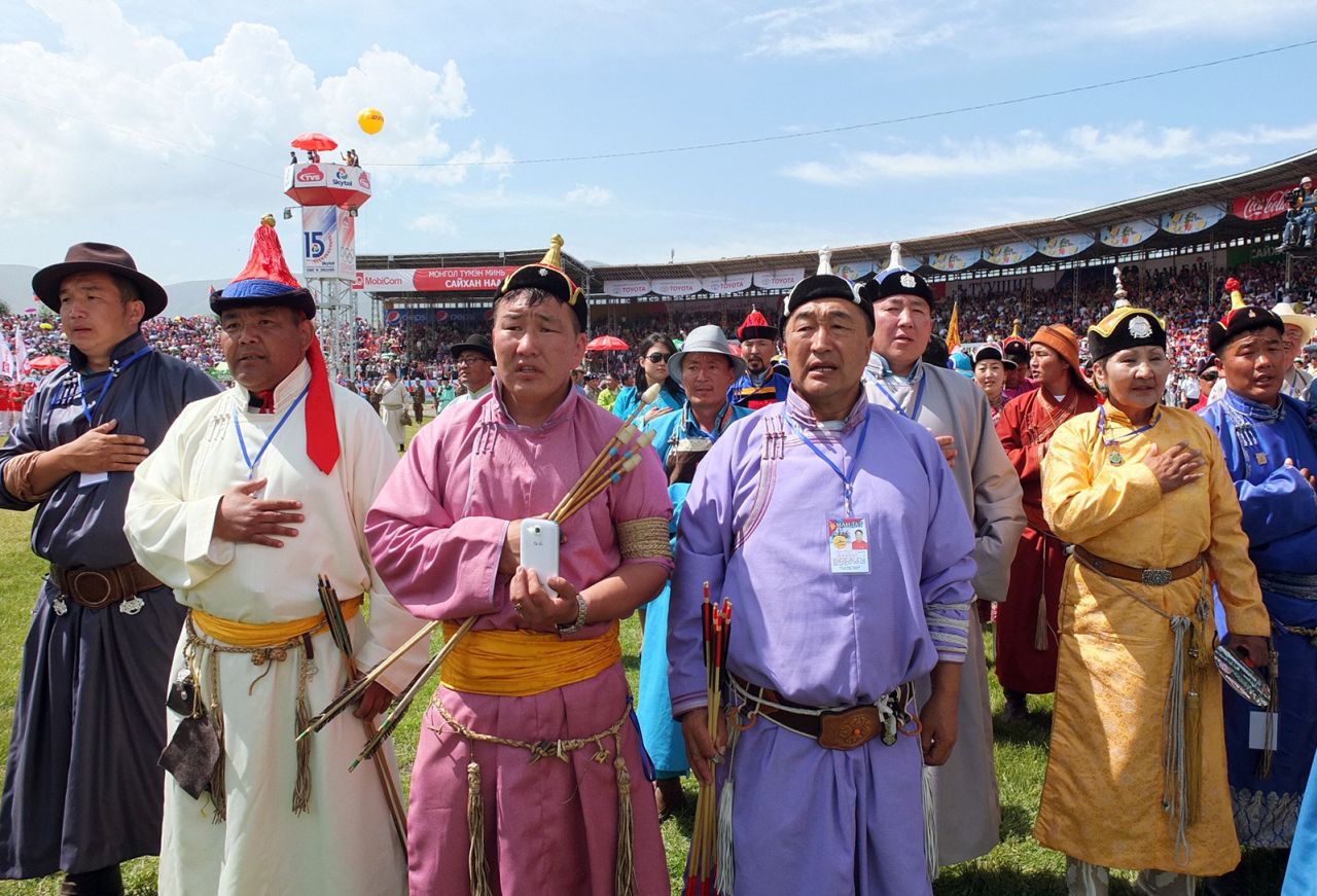 ULAN BATOR, Mongolia - Archery players sing a national anthem during an opening ceremony of the Naadam, a traditional summer sports event in Mongolia, at the Central Stadium in Ulan Bator on July 11, 2014. Participants compete in Mongolian wrestling, horse racing and archery during the two-day event. (Kyodo)