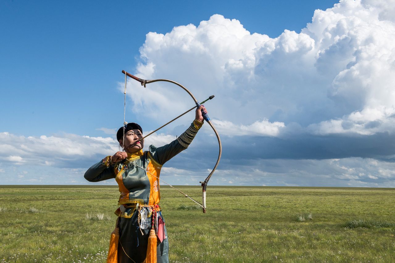 A female archer strikes a pose at small Naadam festival at Three Camel Lodge, Gobi Desert, Mongolia on September 1, 2019. (Photo by Alison Wright/Getty Images)