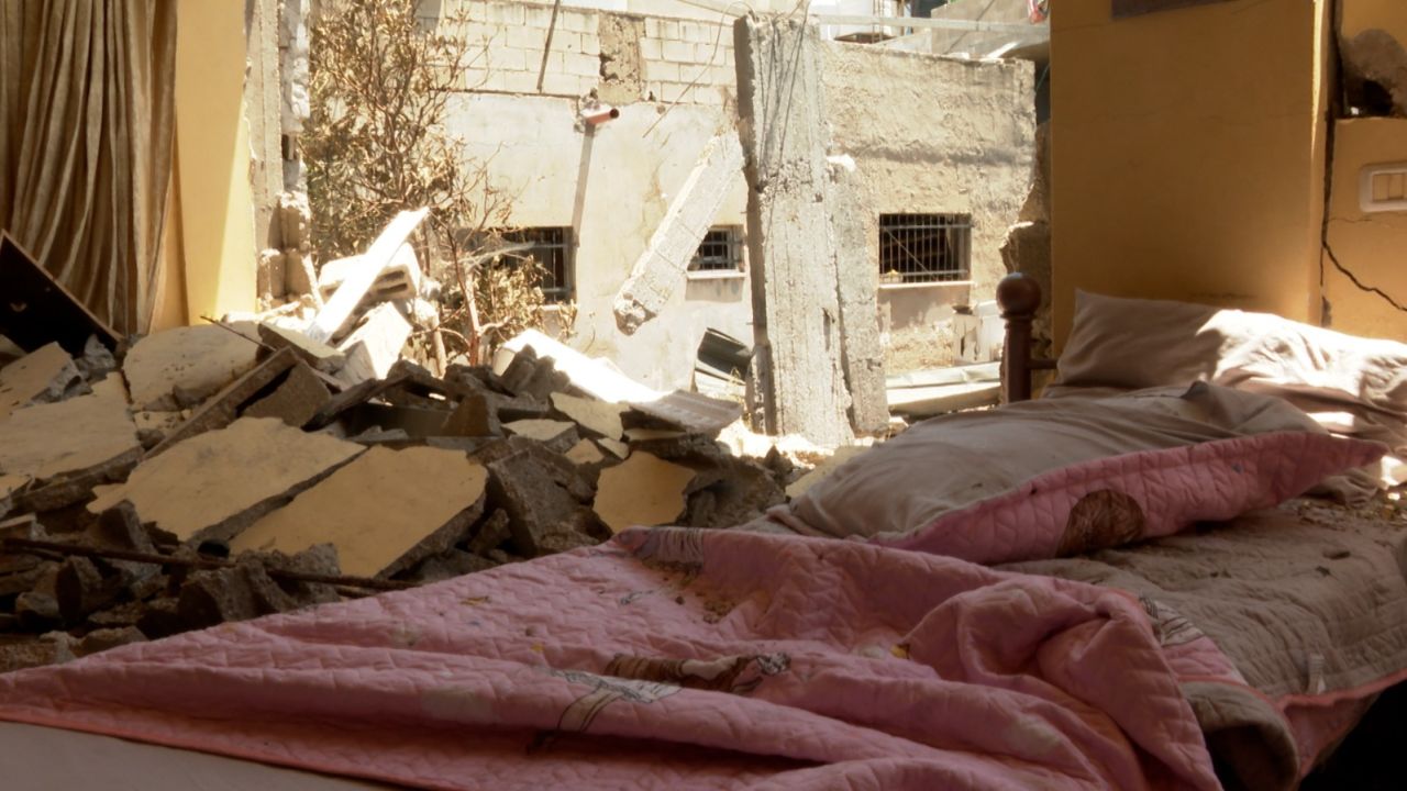 The back wall of Hanaa al-Shalaby's daughters' room was blown out, leaving chunks of rubble on a small bed.