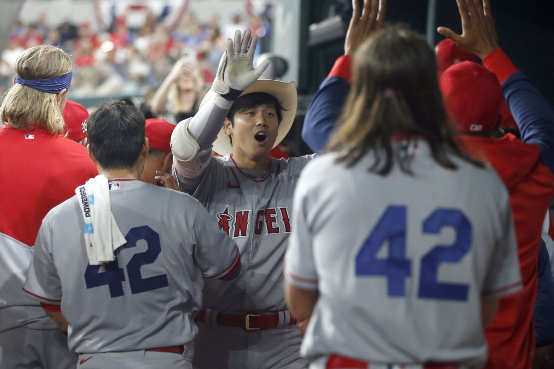 ARLINGTON, TEXAS - APRIL 15: Shohei Ohtani #17 of the Los Angeles Angels is congratulated after hitting a home run in the fifth inning against the Texas Rangers at Globe Life Field on April 15, 2022 in Arlington, Texas. All players are wearing the number 42 in honor of Jackie Robinson Day.   (Photo by Tim Heitman/Getty Images)