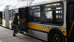A passenger boards the 28 Free Bus at Ruggles Station in Boston, MA, on March 13, 2023.
