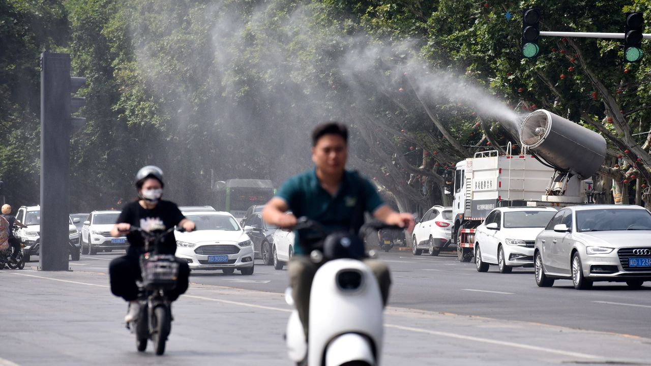 A fog cannon truck sprays water to cool citizens on Zhonghua Street in Handan, North China's Hebei province, July 6, 2023.