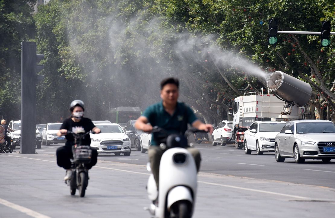 A fog cannon truck sprays water to cool citizens on Zhonghua Street in Handan, North China's Hebei province, July 6, 2023. 