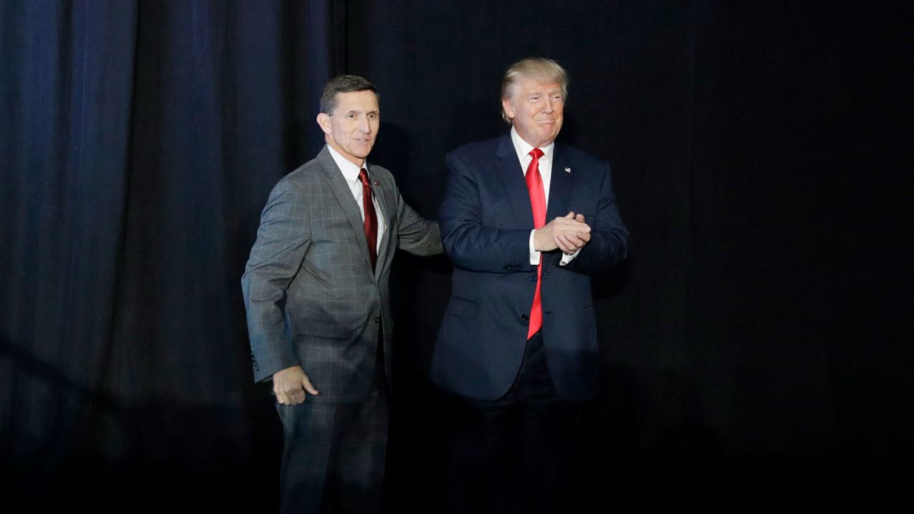 In this September 29, 2016, file photo, retired Gen. Michael Flynn, left, introduces then-Republican presidential candidate Donald Trump at a campaign rally, in Bedford, New Hampshire.