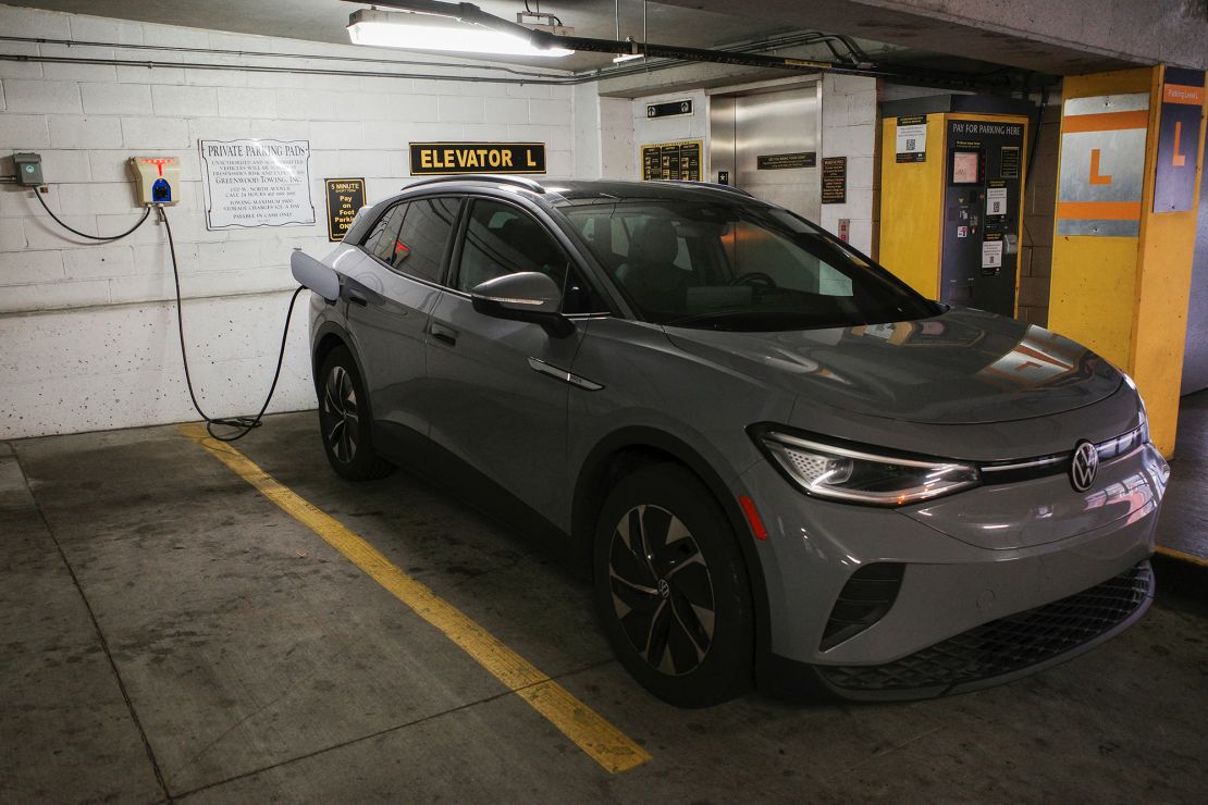 A Volkswagen ID.4 electric vehicle charges at an EV charging station.