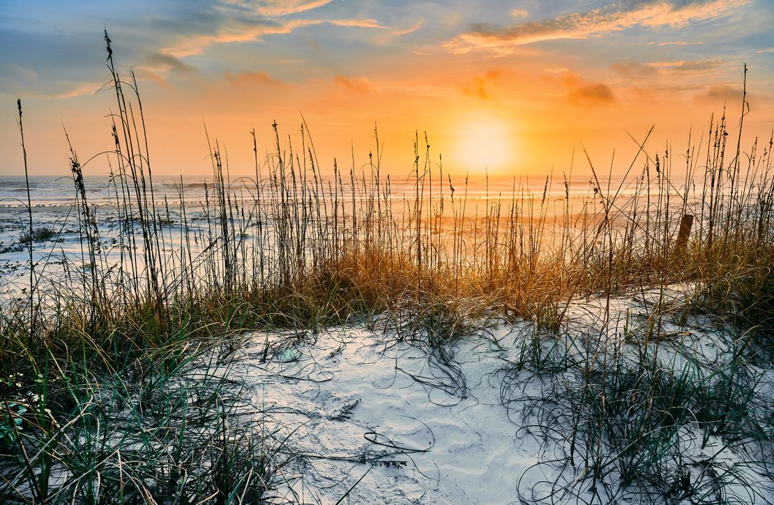 sunrise seen from white sandy beach of Cumberland Island National Seashore's undisturbed wilderness in a winter morning.