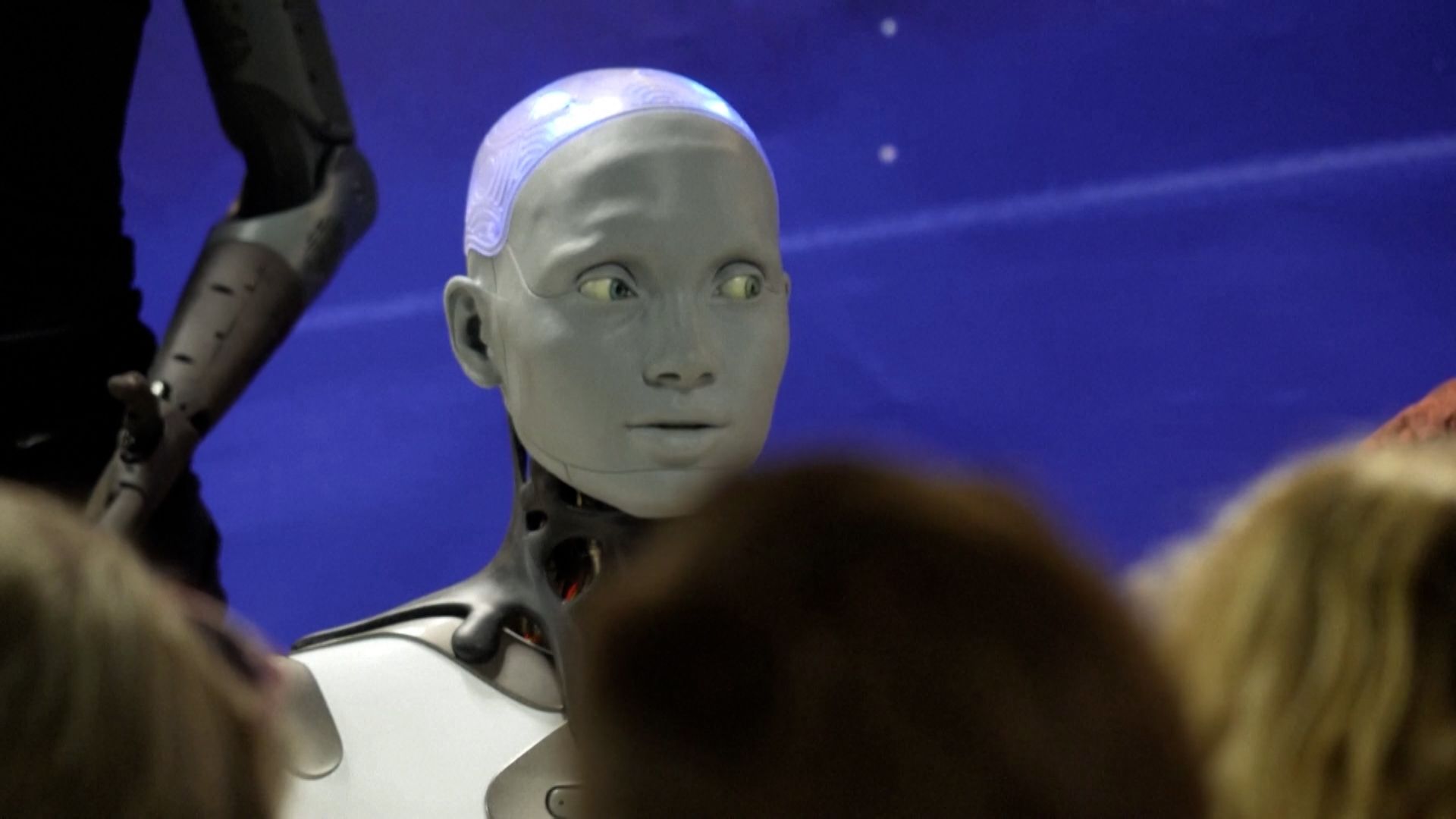 AI-powered humanoid robots field questions from reporters