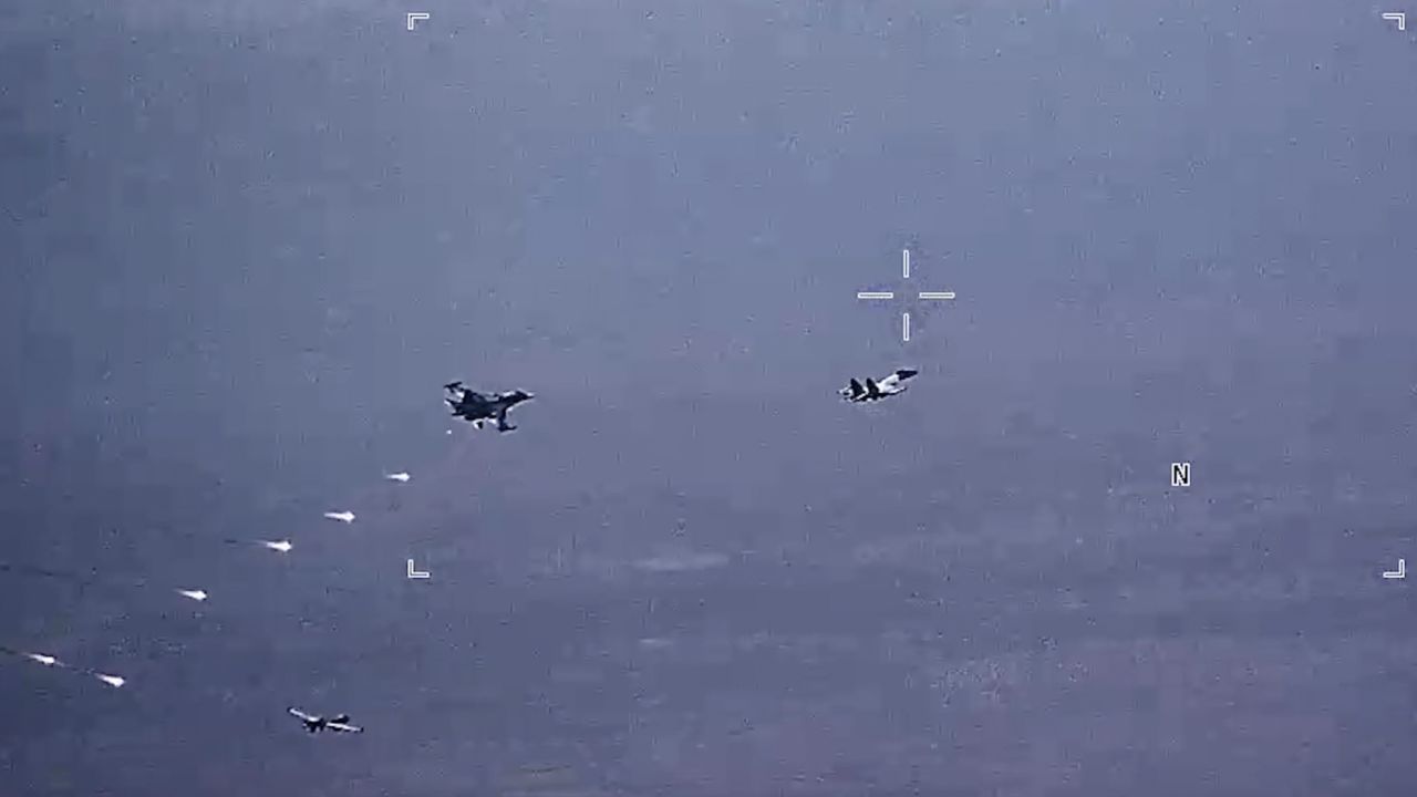In this image from video released by the U.S. Air Force, Russian military SU-34 and SU-35 aircraft release flares in the flight path of a U.S. Air Force MQ-9 Reaper drone, lower left, on Thursday, July 6, 2023, over Syria. 