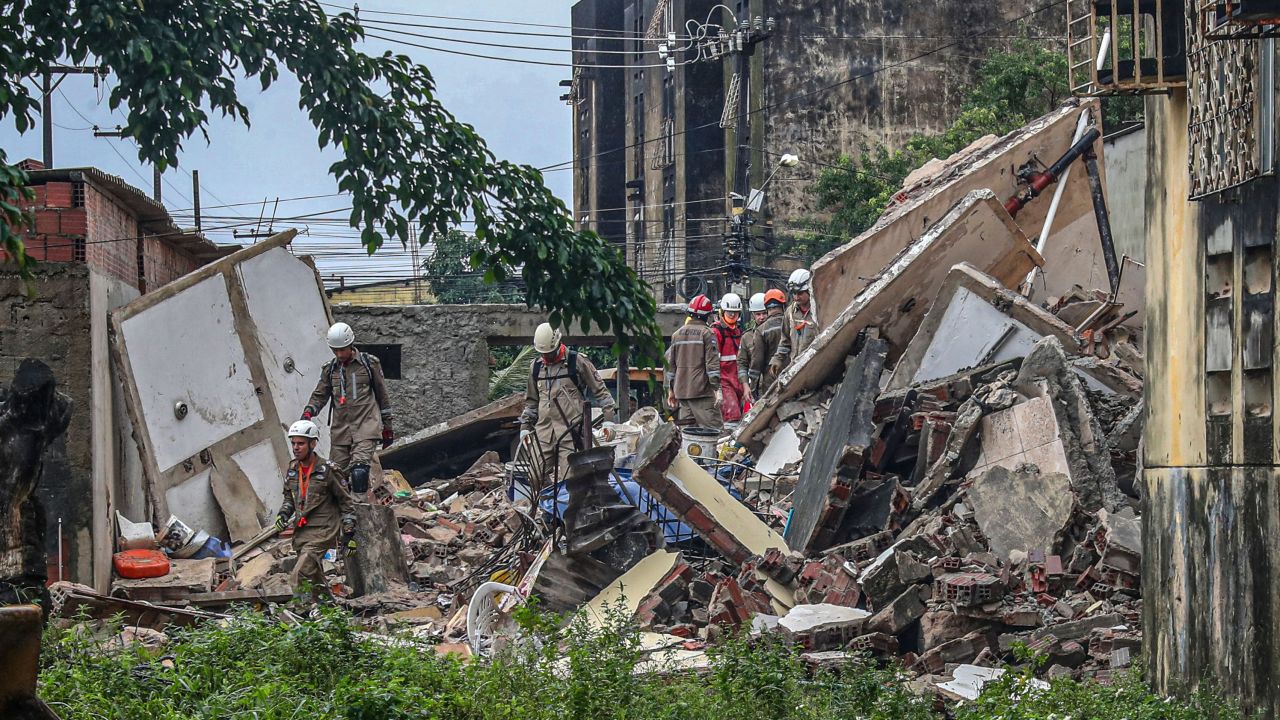 Rescuers search for survivors under the rubble of the collapsed building.