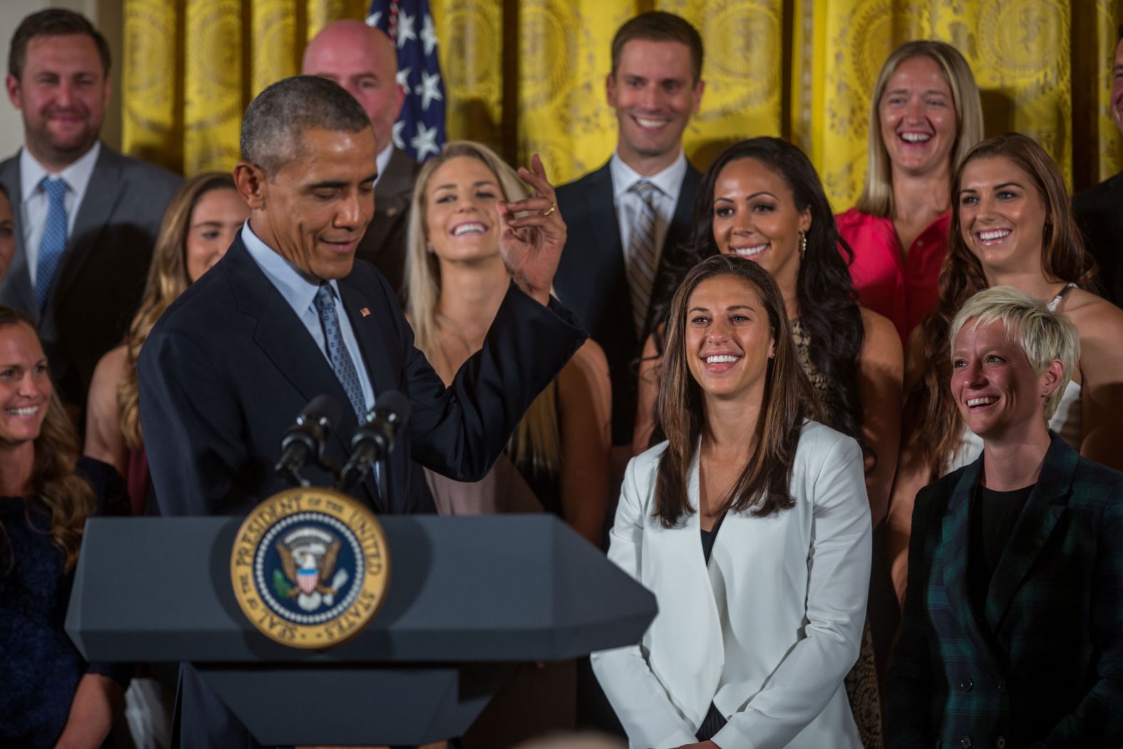 Rapinoe, far right, looks on with her teammates as then-President Obama welcomes them to the White House in October 2015. The visit was in honor of their World Cup victory.