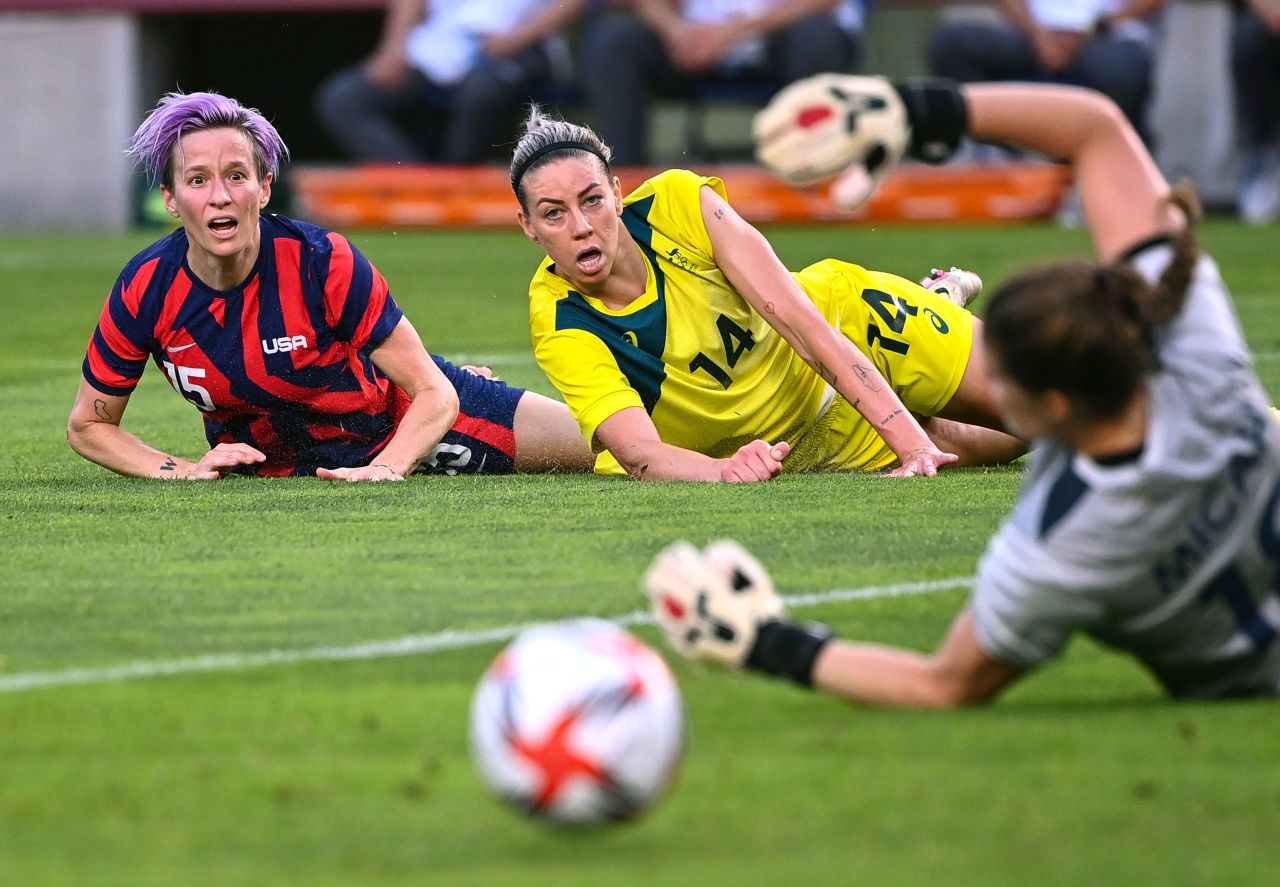 Rapinoe watches the ball with Australia's Alanna Kennedy during the bronze medal match of the Tokyo Olympics. Rapinoe scored two goals during the match, lifting her team to a 4-3 victory.