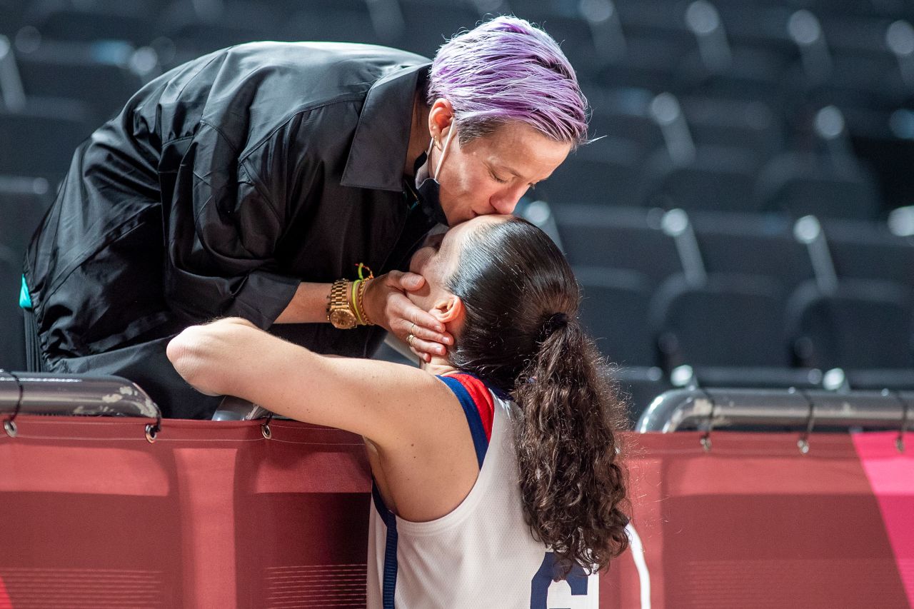 Rapinoe kisses her fiancée, American basketball player Sue Bird, after the United States defeated Japan in the women's basketball gold medal game at the Tokyo Olympics in August 2021. Rapinoe and Bird met at the 2016 Olympics and were engaged in 2020.