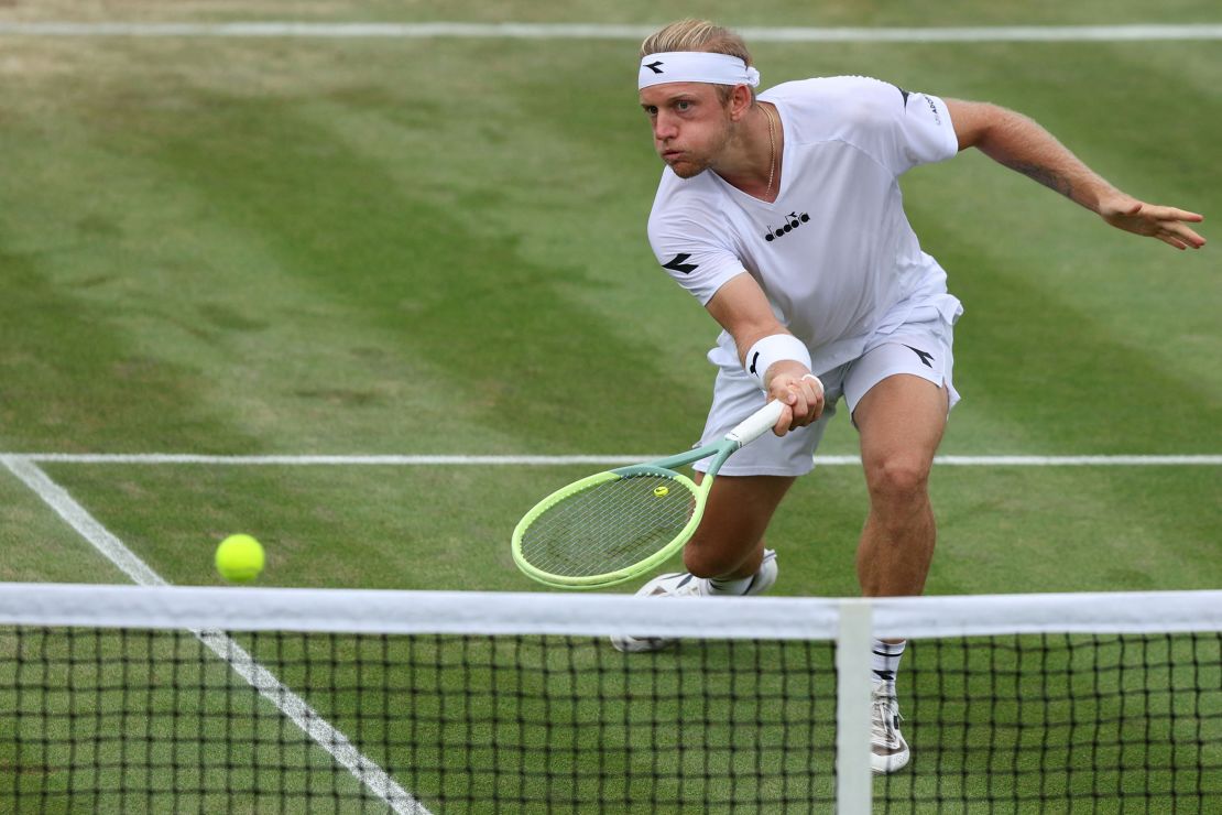 Spain's Alejandro Davidovich Fokina returns the ball to Denmark's Holger Rune during their men's singles tennis match on the sixth day of the 2023 Wimbledon Championships at The All England Tennis Club in Wimbledon, southwest London, on July 8, 2023.