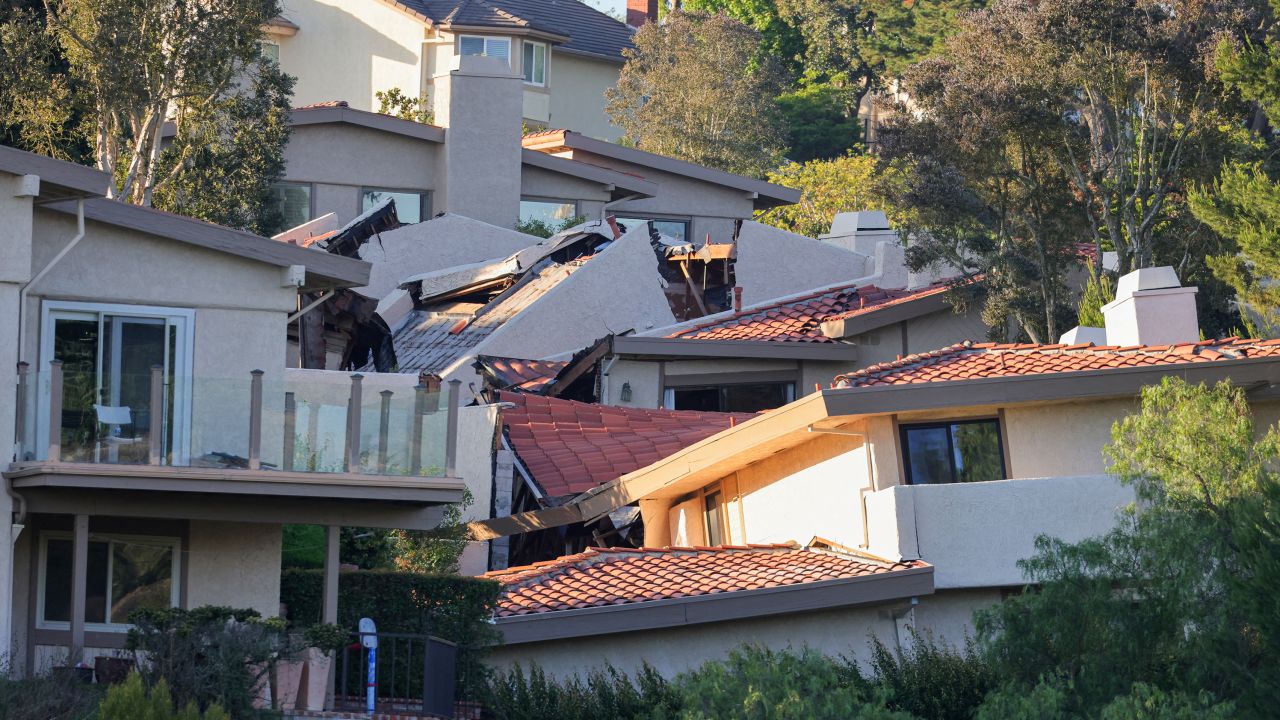 A view shows damaged homes that were evacuated due to a growing crack that caused a landslide in Rolling Hills Estates, California.
