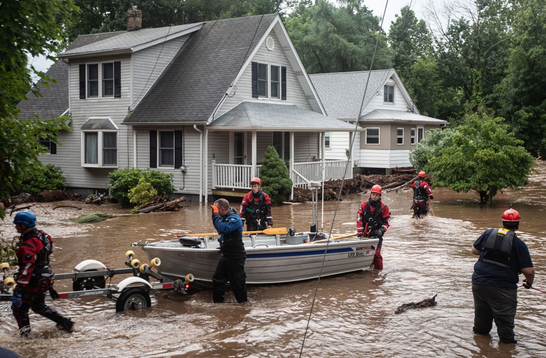 Emergency personnel used a boat to rescue residents of flooded homes on Lowland Hill Road in Stony Point, New York,  on Sunday.