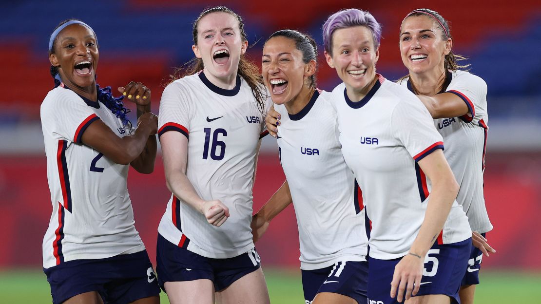 YOKOHAMA, JAPAN - JULY 30: Crystal Dunn #2, Rose Lavelle #16, Christen Press #11, Megan Rapinoe #15 and Alex Morgan #13 of Team United States celebrate following their team's victory in the penalty shoot out after the Women's Quarter Final match between Netherlands and United States on day seven of the Tokyo 2020 Olympic Games at International Stadium Yokohama on July 30, 2021 in Yokohama, Kanagawa, Japan. (Photo by Laurence Griffiths/Getty Images)
