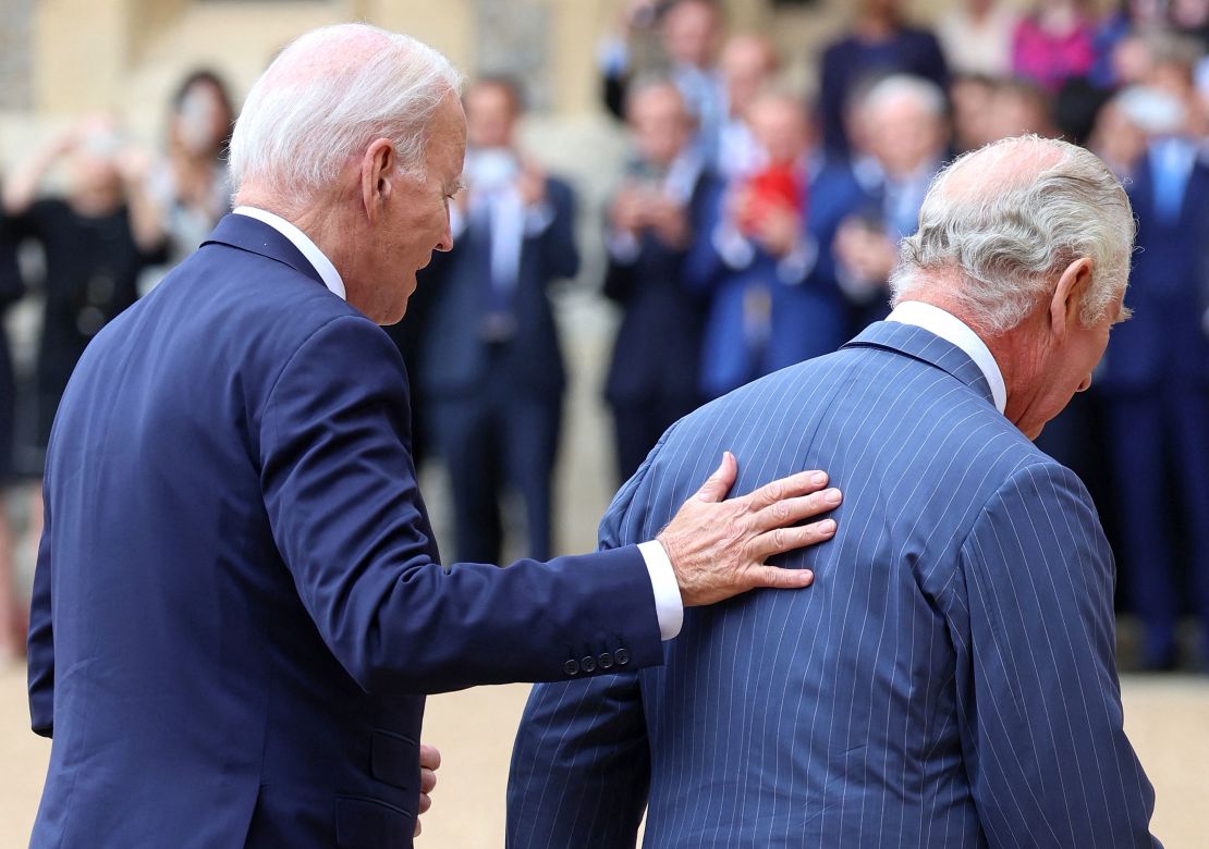 US President Joe Biden places his hand on the back of Britain's King Charles III as they walk in the Quadrangle after ceremonial welcome at Windsor Castle in Windsor on July 10, 2023. US President Joe Biden was in Britain on Monday, where he met with Prime Minister Rishi Sunak and King Charles III, before going on to a NATO summit in Lithuania. (Photo by Chris Jackson / POOL / AFP) (Photo by CHRIS JACKSON/POOL/AFP via Getty Images)