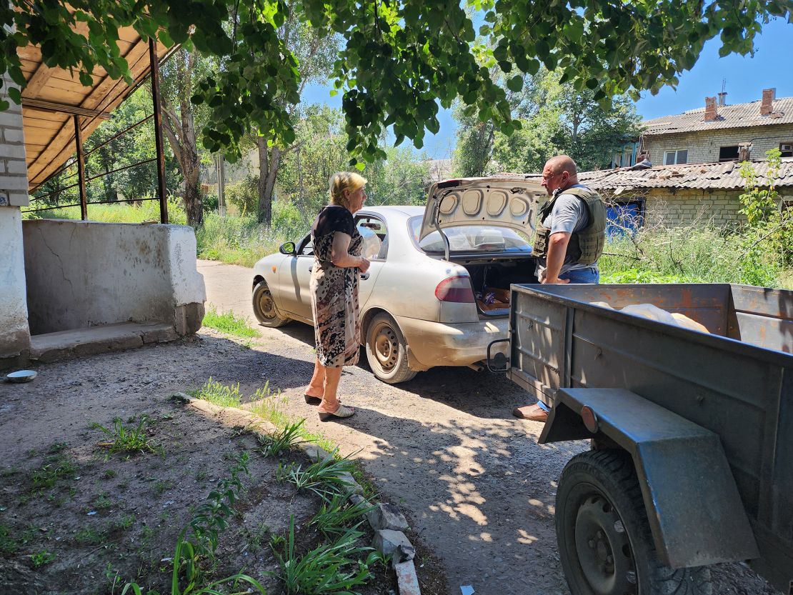 Olha, left, has taken up the task of distributing the bread delivered by volunteers.