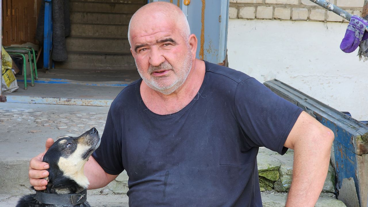 Oleksandr, a retired train driver, doesn't go anywhere without his dog Malysh.