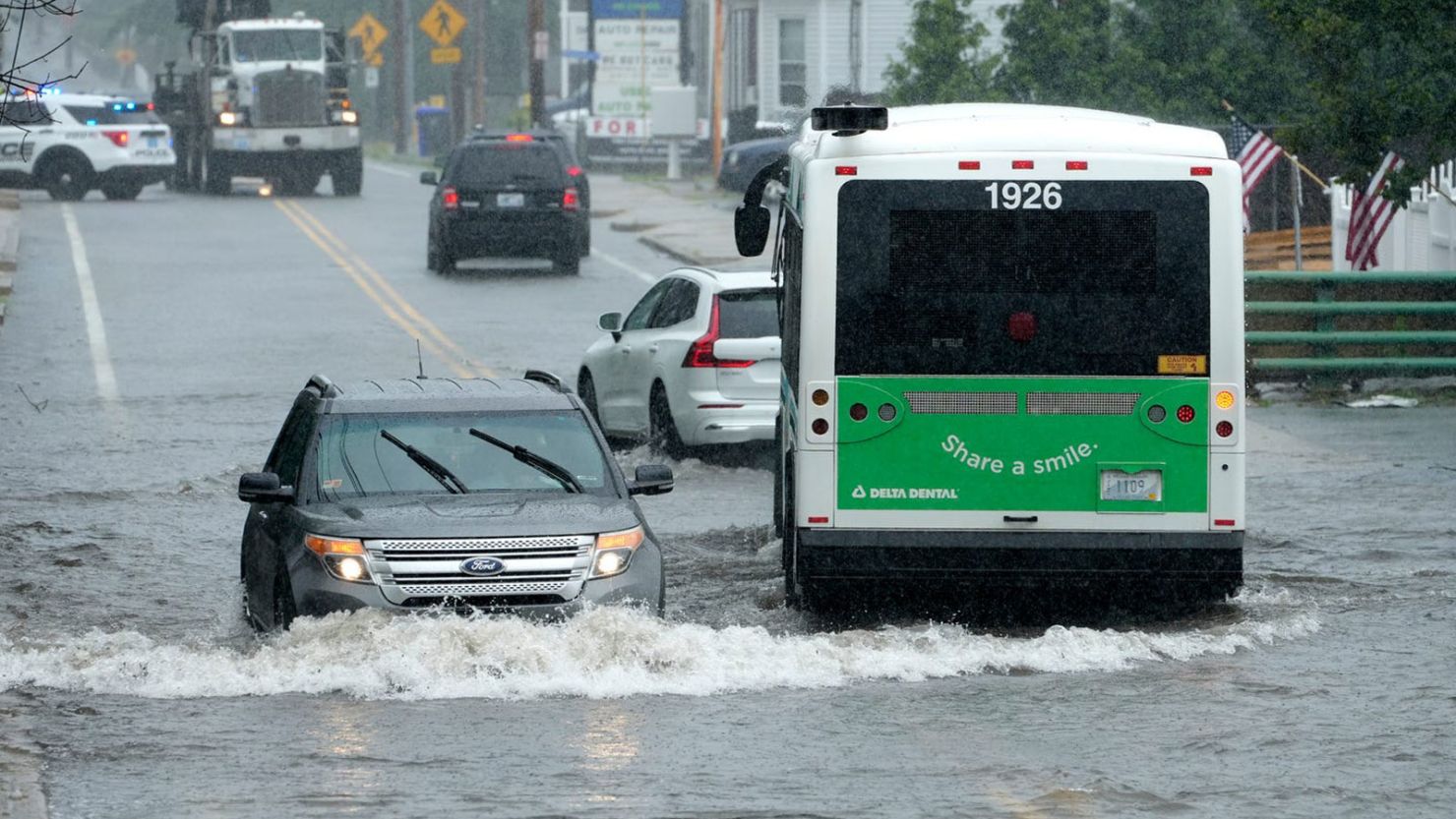 Downpours flood portions of Douglas Ave., in North Providence, Rhode Island, on Monday.