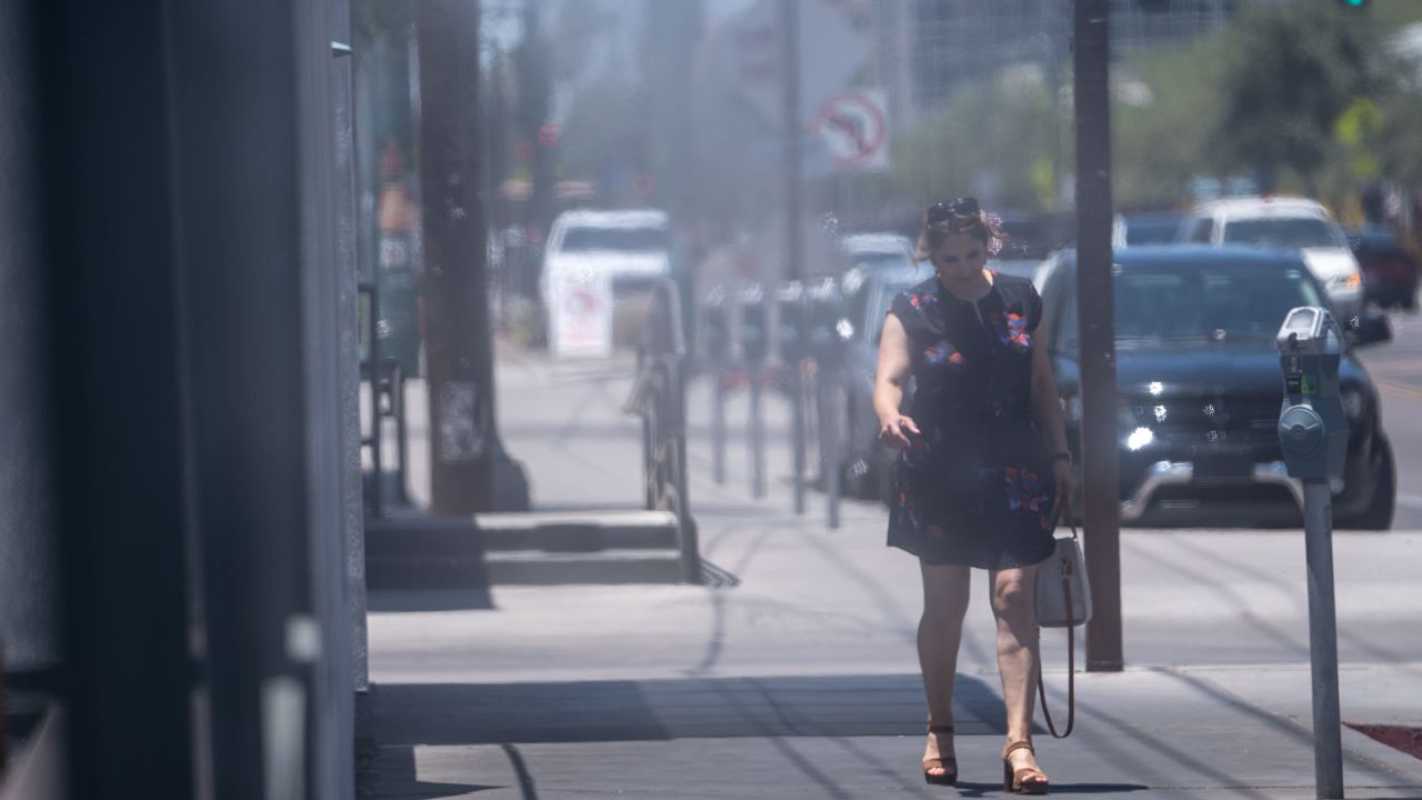 A person walks along Roosevelt Row in Phoenix on July 5. High temperatures there could stay north of 110 degrees through this week.