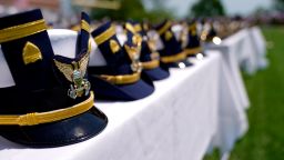 Hats are displayed on a table during the commencement for the United States Coast Guard Academy in New London, Connecticut, on May 19, 2021.