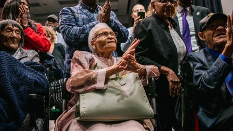 TULSA, OKLAHOMA - JUNE 01: (L-R) Survivors Lessie Benningfield Randle, Viola Fletcher, and Hughes Van Ellis sing together at the conclusion of a rally during commemorations of the 100th anniversary of the Tulsa Race Massacre on June 01, 2021 in Tulsa, Oklahoma. President Biden stopped in Tulsa to commemorate the centennial of the Tulsa Race Massacre. May 31st of this year marks the centennial of when a white mob started looting, burning and murdering in Tulsa's Greenwood neighborhood, then known as Black Wall Street, killing up to 300 people and displacing thousands more. Organizations and communities around Tulsa continue to honor and commemorate survivors and community residents. (Photo by Brandon Bell/Getty Images)
