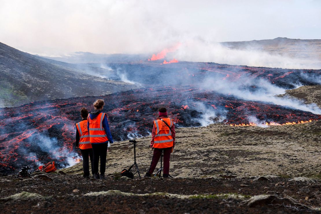 Observers from the University of Iceland watch a volcanic eruption near Litli Hrutur, Iceland on July 10, 2023.