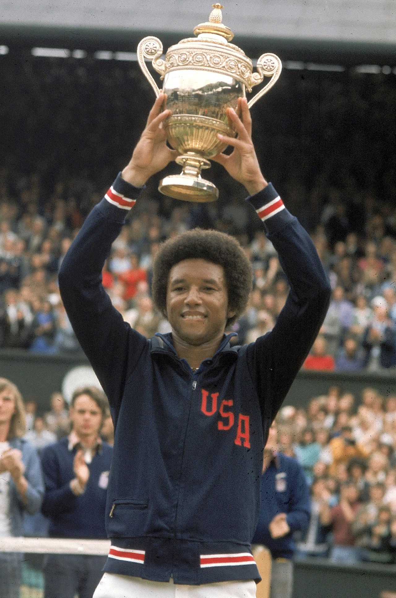 Tennis: Wimbledon: USA Arthur Ashe victorious with trophy after winning Finals match vs USA Jimmy Connors at All England Club.
London, England 7/7/1975
CREDIT: Tony Triolo (Photo by Tony Triolo /Sports Illustrated via Getty Images)
(Set Number: X19662 )